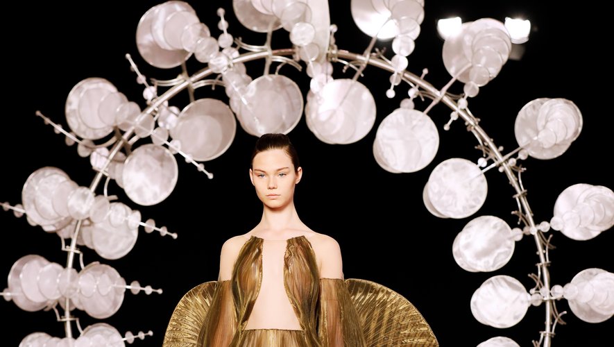 Tout droit sorties d'un songe, les créations d'Iris van Herpen ont essentiellement été conçues à partir de satin et d'organza. Une robe sort du lot, transformant le mannequin en un ange doré. Paris, le 1er juillet 2019.