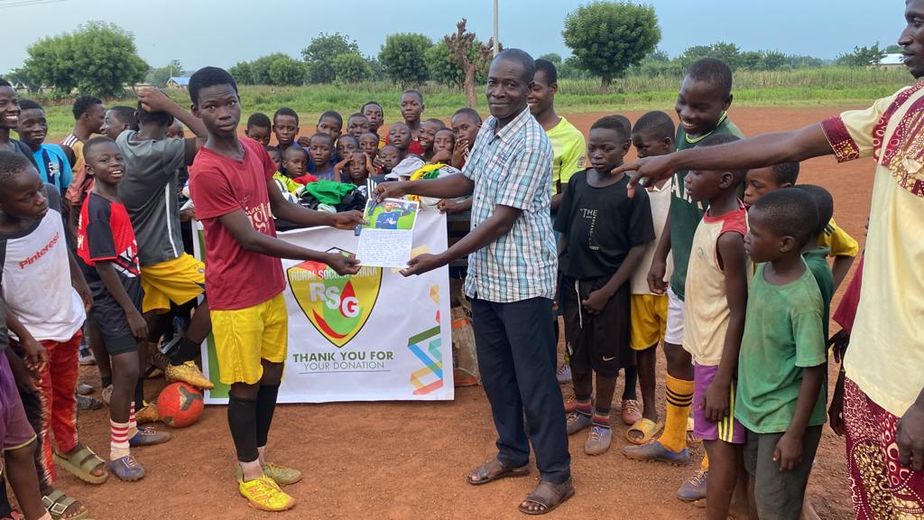Lukman Kadiri, coordinateur de RSG à Tamale au Ghana, qui distribue une lettre aveyronnaise à un des enfants à qui elle était adressée.