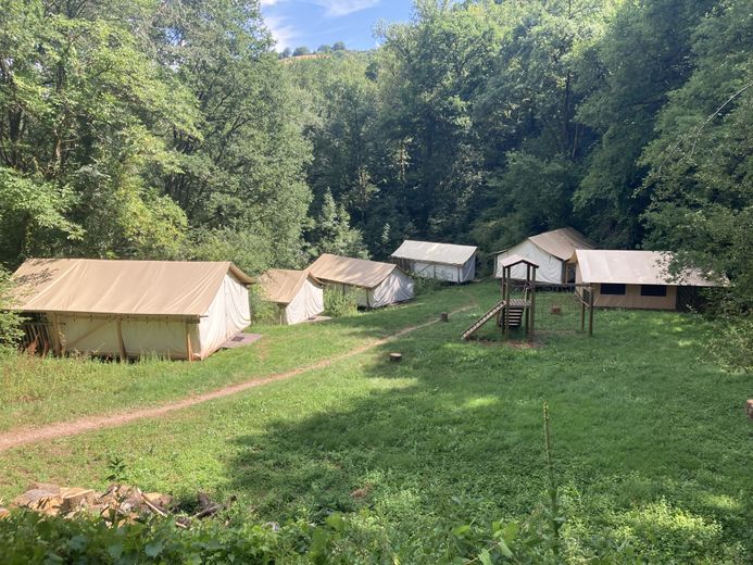 Des lodges installés dans une prairie.